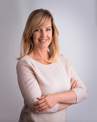 Blond haired woman standing against isolated background