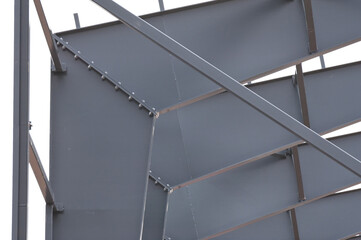 Metal construction, in the photo the structure of the building frame made of metal beams against...