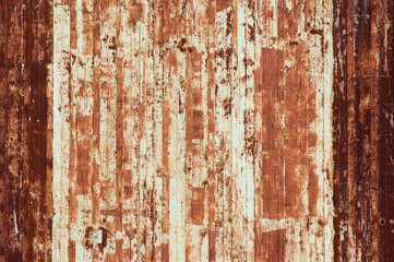 The photo shows a close-up of a rusty metal wall