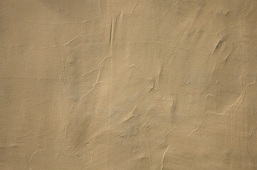 brown background, photo shows texture of plaster on the wall of a building