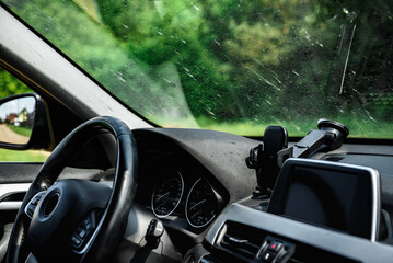 Smeared and dirty front windshield of a vehicle after hitting bugs.