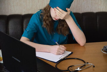 Healthcare worker in distress after a long shift in a medical facility