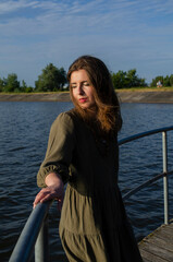 A girl with a guitar in cowboy style. Cowboy hat and boots. Sunny atmospheric photos.