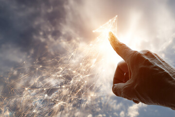 A hand points upwards, touching a glowing, digital number one formed from interconnected light lines against a cloudy sky.