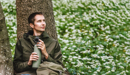 Man Walking through Blooming Forest Glade