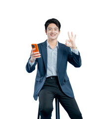 A happy Asian businessman holds a smartphone and makes an 