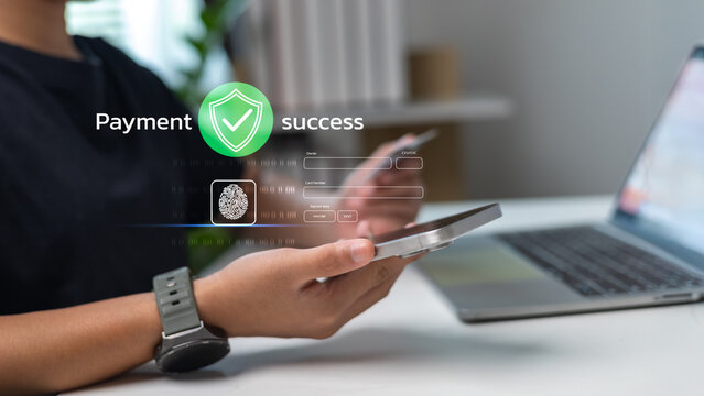 A person using a smartphone and a credit card with biometric fingerprint authentication. Secure online payment system with a successful transaction confirmation screen.