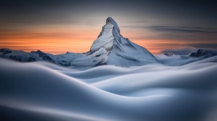 A majestic snowy mountain rises above swirling clouds at sunset