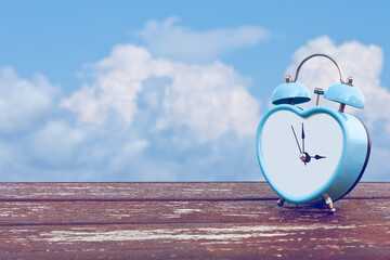 alarm clock on the background of the sky