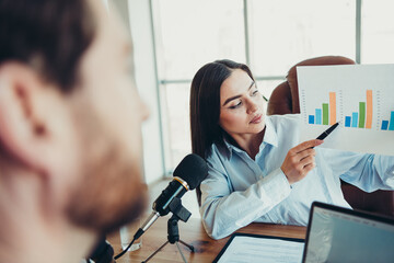 Professional business discussion in a modern coworking space focusing on data analytics and teamwork collaboration insights.