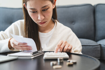 Close-up person using a calculator to  plan monthly expense and account