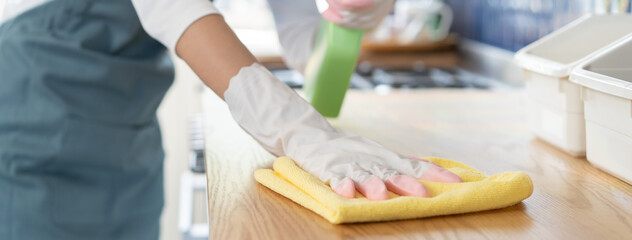 Close-up woman use small towel cleaning kitchen