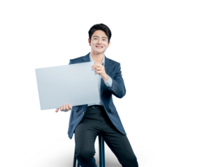 young Asian businessman holds a blank white sign for your message or advertisement while sitting on a stool against a PNG background