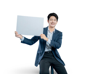 young professional in a suit holds up a blank white placard, smiling warmly for a positive...