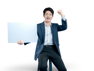 A successful young businessman holds a blank sign and cheers with a fist pump, celebrating a winning announcement or promotion.
