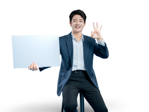 A happy Asian businessman holds a blank sign and makes an "OK" gesture, indicating a perfect deal, result, or excellent service.
 - Powered by Adobe