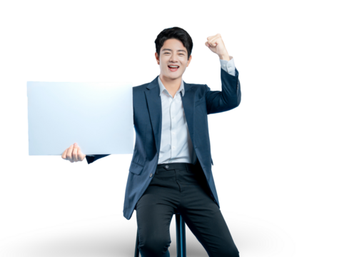 A successful young businessman holds a blank sign and cheers with a fist pump, celebrating a winning announcement or promotion.
