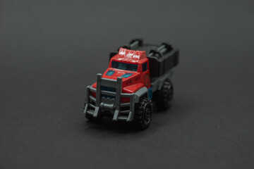 Military car toys featuring a red fire truck with a black bed, perfect for childrens playtime or toy collection displays.