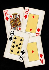 A montage of four vintage playing cards isolated on a black background.