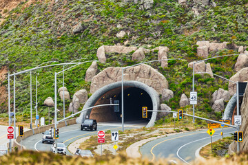 Tom Lantos Tunnel at Devils Slide on scenic Highway 1, surrounded by lush coastal hills near Pacifica, California. Iconic gateway to the Pacific coast drive