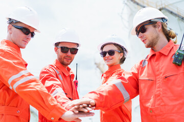 Team of engineers touching hands together to express a good collaboration and teamwork.