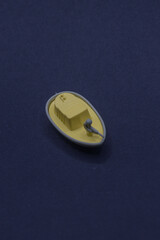 Yellow toy boat on dark blue surface, ideal for childrens book illustrations, summerthemed designs, or nauticalthemed projects. Suitable for marketing materials.