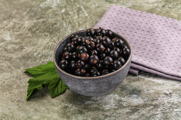 Ripe black currant in the bowl