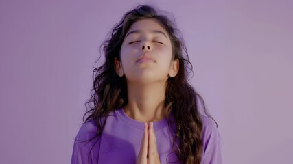 Young girl meditating with eyes closed in calm studio environment