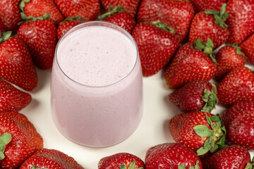 Freshly made strawberry milkshake with milk, ice cream and strawberries