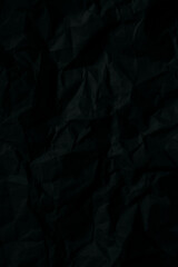 Macro black crumpled paper background and I want it,black crumpled paper background, rough page texture,Close-up detail black color background from sheet of crumpled carton.