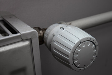 White thermostatic head on the battery. Heat regulation in the house