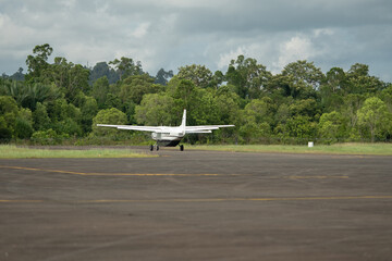 Slow motion video of a small turboprop plane lands at a remote airport