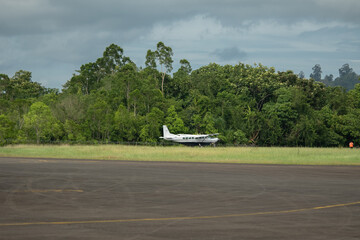Slow motion video of a small turboprop plane lands at a remote airport