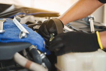Mechanic Removing Car Belt in Auto Repair Shop