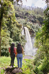 Tourists observing the Kimsa Waterfall, located in the Rumiñahui canton, 15 kilometers from Sangolquí, in the Molinuco Ecological Reserve, Ecuador. The waterfall is approximately 60 meters high.