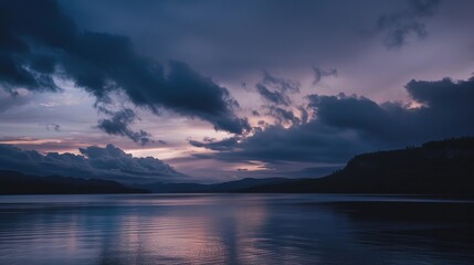 Obraz premium Moody Cloudy Twilight Landscape with Layered Cumulus Clouds and Diffused Sunset Glow, Atmospheric Scenery Featuring Silhouetted Trees and Low-Contrast Color Gradient