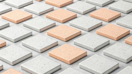 Fototapeta premium Arrangement of square tiles in alternating colors of gray and peach creating a geometric pattern