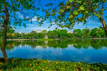 View of Turtle Tower at Hoan Kiem Lake in spring with beautiful reflection, an important historical building in Hanoi, Vietnam
