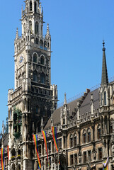 the  gothic New City Hall in Munich decorated with the LGBT flags, June 2025