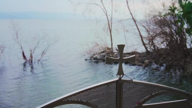Entrance to baptism site in Sea of Galilee in Israel sacred to Christians. Worship and holy place. Metal gate with a cross. Site for pilgrims and believers of Jesus Christ coming to tour in Holy Land