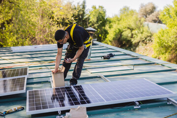 Technician installing solar panels on a roof on a sunny day