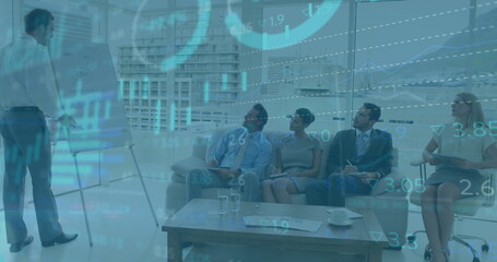 In office, diverse professionals presenting financial data with image overlaying on screen