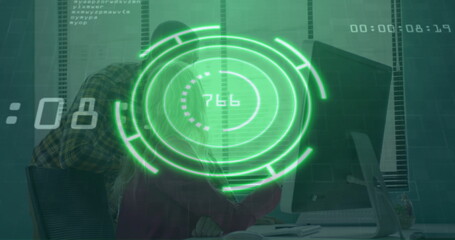 Collaborating coworkers analyzing green holographic interface at office desk, monitor keyboard