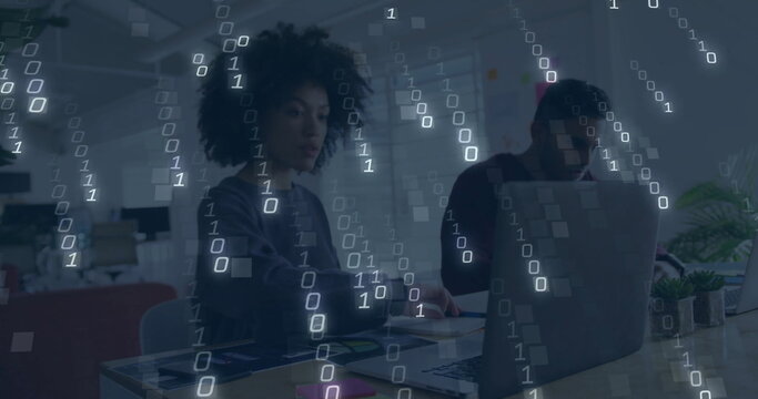 Binary code image over diverse people working on laptops in office