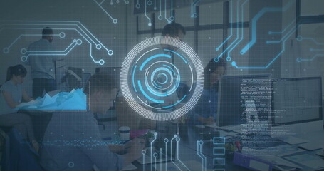 Displaying HUD overlay above team coding in open-plan office, with monitors, laptops and tablet