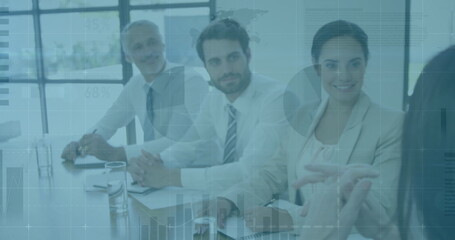 Four colleagues in business attire leading discussion around glass table in office with notebooks