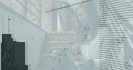 Using tablet, businesswoman analyzing financial graphs and data with image