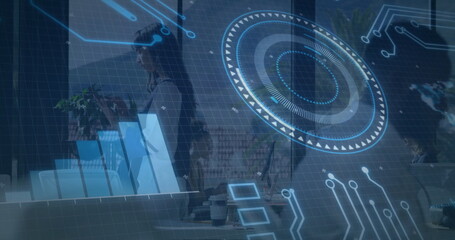 Using tablet, businesswoman analyzing digital data with image in office