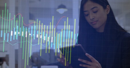 Analyzing financial graph overlay, businesswoman using tablet for data in office