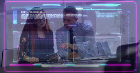 Pointing colleagues analyzing tablet data at conference table, with documents, pen, data overlays